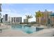 Rooftop pool area with comfortable lounge seating, palm trees, and scenic city views at 301 Quay Commons # 1610, Sarasota, FL 34236