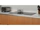 Close-up of a modern induction stovetop with sleek countertops and minimalist design details at 301 Quay Commons # 1610, Sarasota, FL 34236
