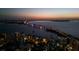 Aerial view of a lit up bridge over the water, with buildings and homes surrounding at 301 Quay Commons # 507, Sarasota, FL 34236