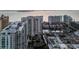 An aerial view of a waterfront residential community featuring modern architecture, a fountain entrance, and a marina at 301 Quay Commons # 507, Sarasota, FL 34236