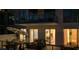 Balcony view showcases an outdoor living space with lounge seating, dining, and nighttime ambiance at 301 Quay Commons # 507, Sarasota, FL 34236