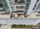 Aerial view of the balcony, showcasing multiple seating and dining arrangements for outdoor relaxation and entertainment at 301 Quay Commons # 507, Sarasota, FL 34236