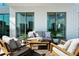 A modern balcony featuring comfortable outdoor seating, creating an inviting space for relaxation with city views at 301 Quay Commons # 507, Sarasota, FL 34236