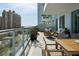A large, inviting balcony features comfortable seating, potted plants, and stunning city views perfect for relaxation and entertaining at 301 Quay Commons # 507, Sarasota, FL 34236