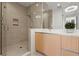 Modern bathroom featuring a sleek shower and a vanity with quartz countertop and wood cabinets at 301 Quay Commons # 507, Sarasota, FL 34236