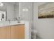 Modern bathroom featuring vanity, updated toilet, glass-enclosed shower and neutral colors at 301 Quay Commons # 507, Sarasota, FL 34236