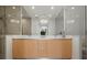 Bathroom showcasing double vanity, modern lighting fixture, and glass shower at 301 Quay Commons # 507, Sarasota, FL 34236