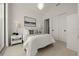 Bright bedroom with a decorative chandelier, closet, and a painting above the bed at 301 Quay Commons # 507, Sarasota, FL 34236