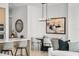 Bright dining area features a modern chandelier, round table, and stylish decor adjacent to the kitchen at 301 Quay Commons # 507, Sarasota, FL 34236