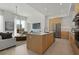 Contemporary kitchen with a large island, stainless steel appliances, and an adjacent living space at 301 Quay Commons # 507, Sarasota, FL 34236