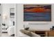 Living room detail showcasing modern decor, art, and a glimpse into a bright bedroom at 301 Quay Commons # 507, Sarasota, FL 34236