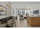 Spacious open-concept living area with modern lighting, floor-to-ceiling windows, and a comfortable seating arrangement at 301 Quay Commons # 507, Sarasota, FL 34236