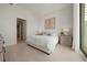 Bright main bedroom with contemporary furnishings, tiled floors, and natural light from floor-to-ceiling windows at 301 Quay Commons # 507, Sarasota, FL 34236