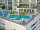Aerial view of condominium pool deck with lounge chairs, tables, and a jacuzzi at 301 Quay Commons # 507, Sarasota, FL 34236