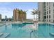 Luxury condominium pool with clear blue water, city views, and palm trees at 301 Quay Commons # 507, Sarasota, FL 34236