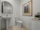 Stylish powder room features a pedestal sink, sleek fixtures, and modern decor at 301 Quay Commons # 507, Sarasota, FL 34236