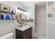 Bathroom featuring a vanity with marble countertop, framed mirror, and a tiled walk-in shower at 309 Glen Oak Rd, Venice, FL 34293