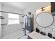 Nicely remodeled bathroom featuring subway tile, updated fixtures, and a modern vanity with a round mirror at 309 Glen Oak Rd, Venice, FL 34293
