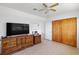 Bedroom featuring a vintage dresser, spacious closet, and a large wall-mounted television at 309 Glen Oak Rd, Venice, FL 34293