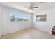 Bright bedroom featuring neutral walls, a ceiling fan, and a large window offering neighborhood views at 309 Glen Oak Rd, Venice, FL 34293