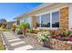 Home exterior features beautiful landscaping with brick planters, flowers and a stone walkway at 309 Glen Oak Rd, Venice, FL 34293