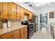 Bright kitchen with wooden cabinetry, stainless steel appliances, and light countertops at 309 Glen Oak Rd, Venice, FL 34293