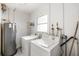 Bright laundry area features a water heater, shelving, and a window that provides natural light at 309 Glen Oak Rd, Venice, FL 34293