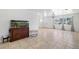 Bright living room with tile flooring, aquarium, and large windows with decorative curtains at 309 Glen Oak Rd, Venice, FL 34293