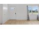 Bright living room with neutral tile flooring, and a window with views of the front yard at 309 Glen Oak Rd, Venice, FL 34293