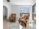 This room has tile flooring, large windows with views, and comfortable upholstered chairs at 309 Glen Oak Rd, Venice, FL 34293