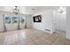 Well-lit living room with tile flooring and large windows, offering a bright and airy space at 309 Glen Oak Rd, Venice, FL 34293