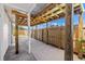 Covered patio with wooden beams and fence, offering ample outdoor space and privacy at 309 Glen Oak Rd, Venice, FL 34293