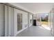 Enclosed porch featuring tile flooring, glass panel doors, and access to the backyard at 309 Glen Oak Rd, Venice, FL 34293