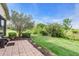Lush backyard with a brick patio and views of the surrounding greenery at 3514 92Nd E Ave, Parrish, FL 34219