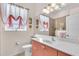 Well-lit bathroom with a large mirror, vanity, and decorative window treatment at 3514 92Nd E Ave, Parrish, FL 34219