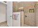 Tiled shower with a glass door and recessed shelving, showcasing bathroom details at 3514 92Nd E Ave, Parrish, FL 34219