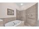 Bathroom featuring a tiled surround, soaking tub, glass shower, and accessibility features at 3514 92Nd E Ave, Parrish, FL 34219