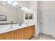 Bathroom with double sinks, wood cabinets, and tiled floor at 3514 92Nd E Ave, Parrish, FL 34219