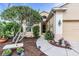 Inviting home featuring a landscaped garden and pathway leading to the front door at 3514 92Nd E Ave, Parrish, FL 34219