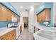 A spacious kitchen featuring wood cabinets, white counters, and tile floors, with dining area access at 3514 92Nd E Ave, Parrish, FL 34219