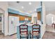A kitchen with blue accent wall, stainless steel appliances, white fridge, and breakfast bar seating at 3514 92Nd E Ave, Parrish, FL 34219