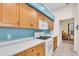 Well-lit kitchen with wood cabinets, white countertops, and modern appliances at 3514 92Nd E Ave, Parrish, FL 34219