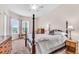 Spacious bedroom with a four-poster bed, carpeted floor, and bright natural light at 3514 92Nd E Ave, Parrish, FL 34219