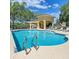 Community pool featuring clear water, lounge chairs, and a covered gathering spot perfect for relaxing at 3514 92Nd E Ave, Parrish, FL 34219