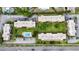 Aerial view of condo complex with well-maintained grounds, a central pool, and ample parking at 3606 Beneva Rd # 506, Sarasota, FL 34232