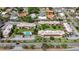 Aerial view of condo complex with well-maintained grounds, a central pool, and surrounding residential neighborhood at 3606 Beneva Rd # 506, Sarasota, FL 34232