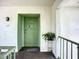 Condo entrance featuring a green front door, potted plant, and textured white walls at 3606 Beneva Rd # 506, Sarasota, FL 34232