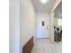 Hallway featuring white tile floors and a white door leading to the apartment interior at 3606 Beneva Rd # 506, Sarasota, FL 34232