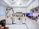 Bright kitchen with white cabinets, appliances, and tile flooring at 3606 Beneva Rd # 506, Sarasota, FL 34232