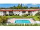 A refreshing in-ground pool is surrounded by green grass and landscaping at this condominium complex at 3606 Beneva Rd # 506, Sarasota, FL 34232
